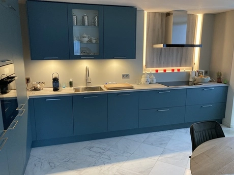 moderne keuken met blauwe kasten en apparatuur