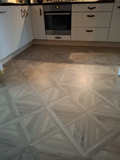keuken met houten vloer en witte kasten