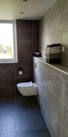 moderne badkamer met zwevend toilet en handdoeken