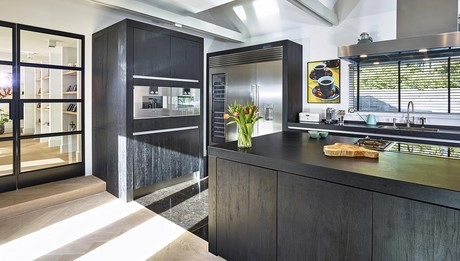 moderne keuken met donkere kasten en bloemen