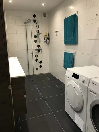 moderne badkamer met wasmachine en droger